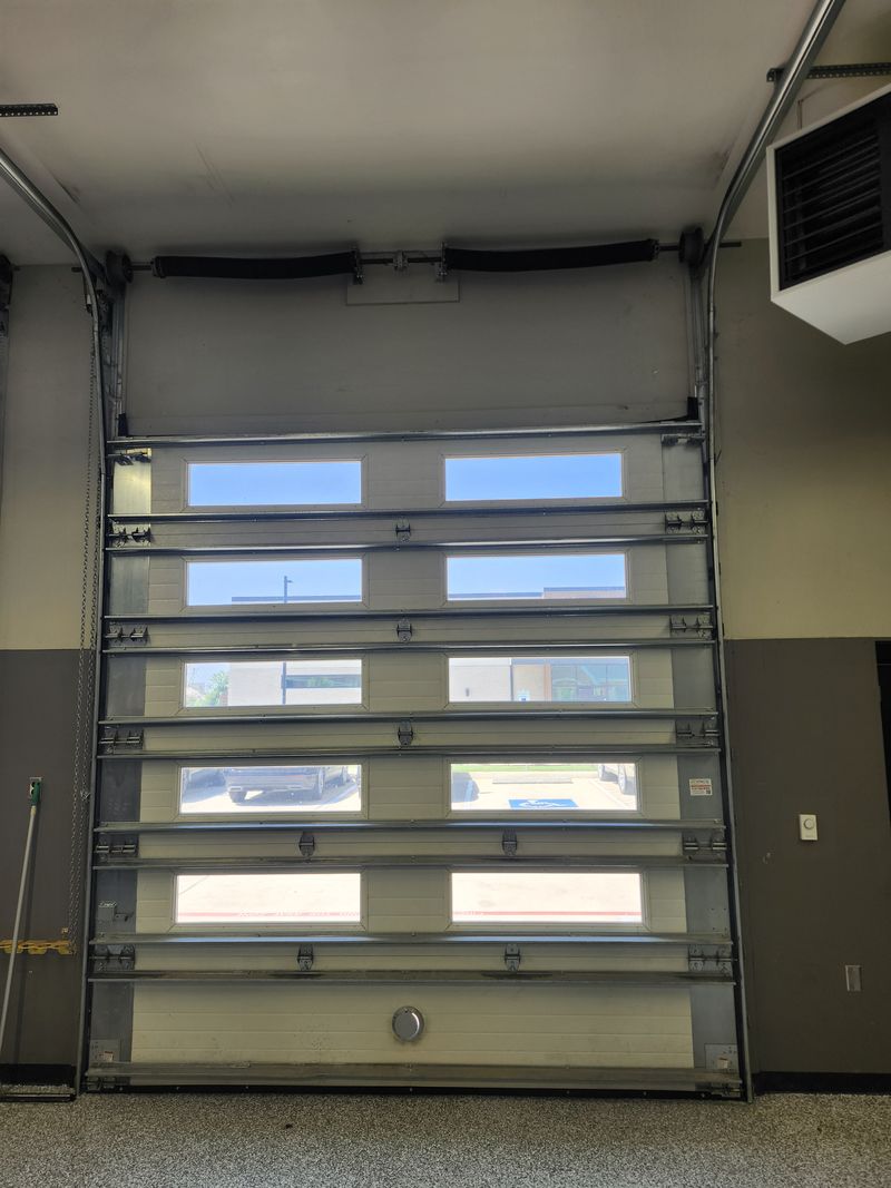Full-view glass garage door running after a cable repair in Argyle, TX