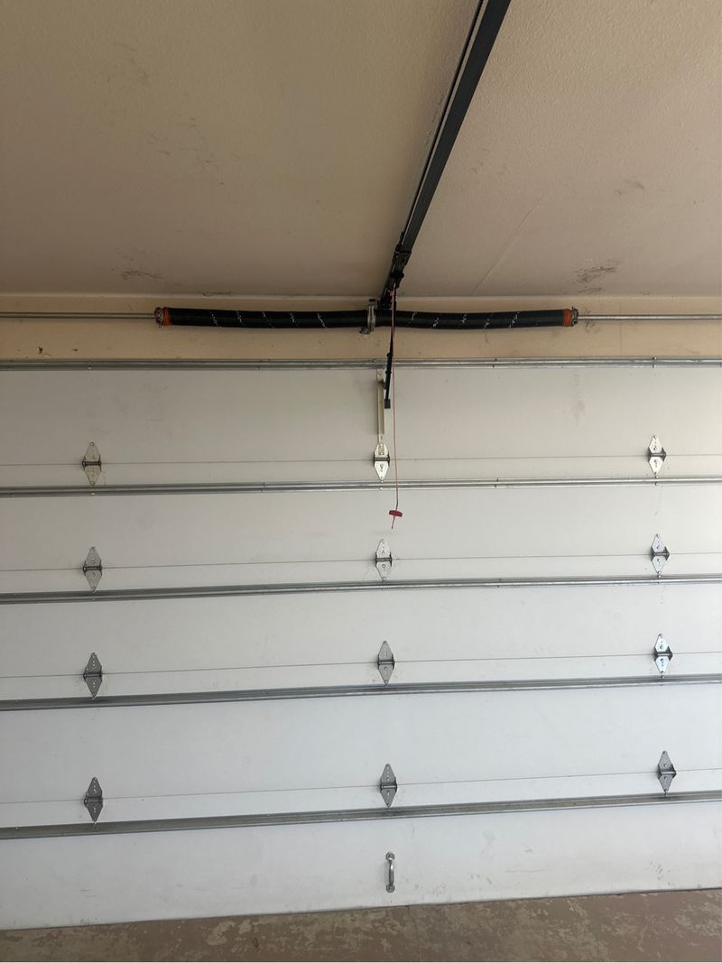 New torsion spring on a white garage door in Argyle, TX