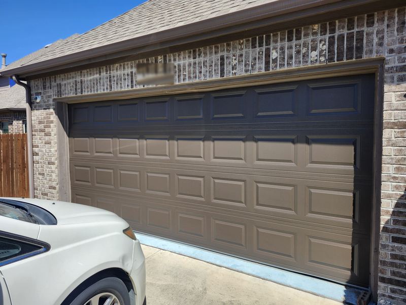 New brown raised-panel steel garage door installed in Frisco, TX