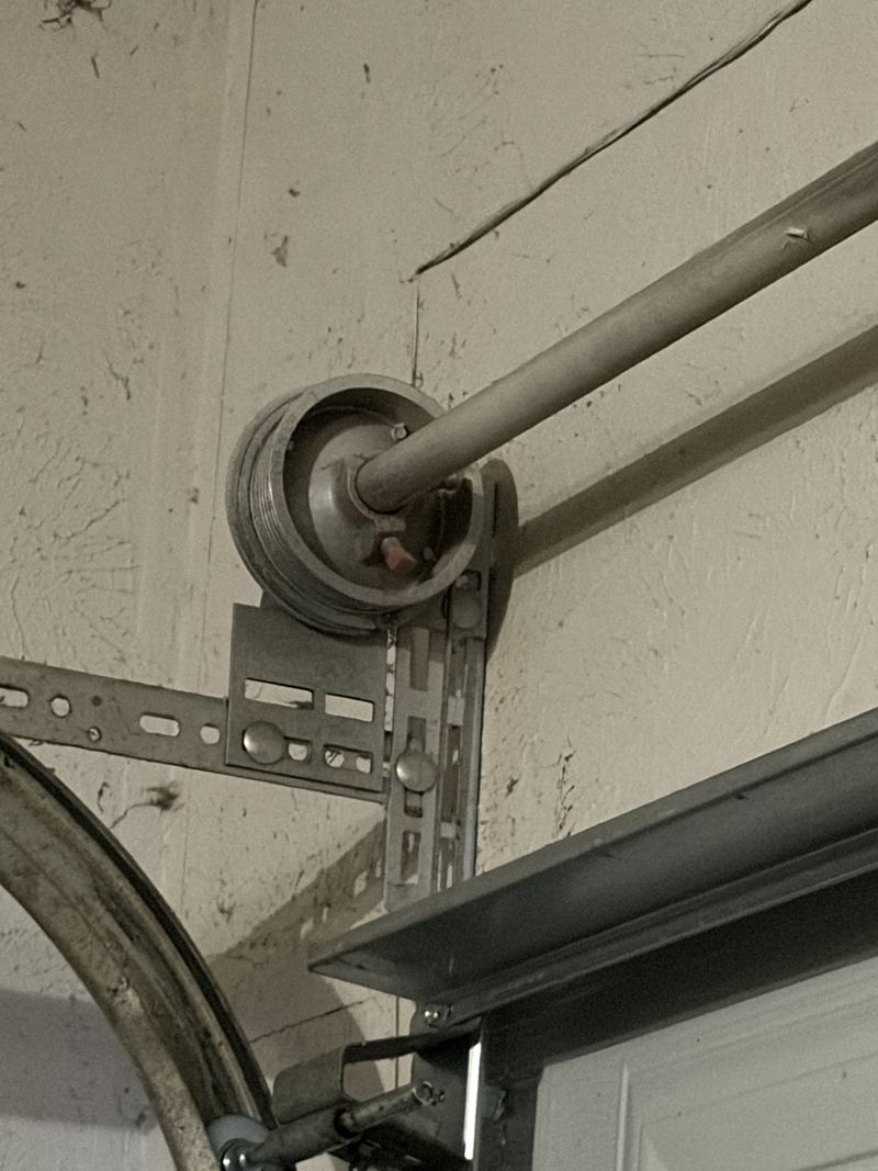 Cable drum and torsion shaft on a garage door repair in Plano, TX