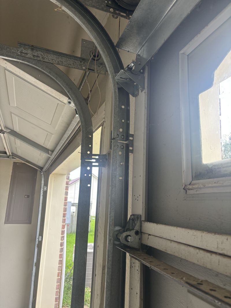 Track and rollers on a garage door with arched windows in Canton, TX