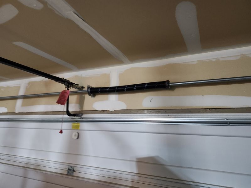 Torsion spring and bar above a garage door in Cross Roads, TX