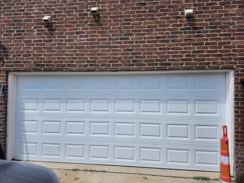 Double-car white steel garage door replacement in Plano, TX