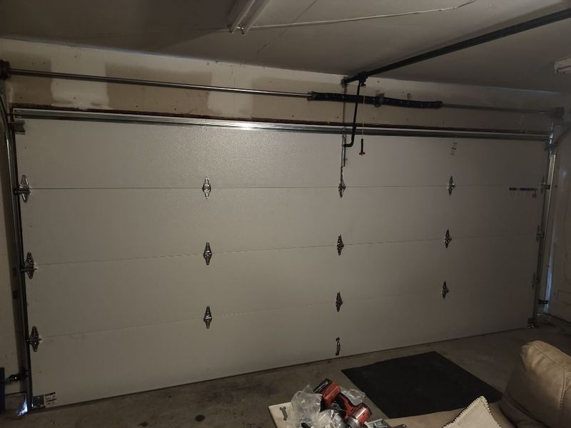 Inside view of a new white double garage door with decorative hardware in Forney, TX