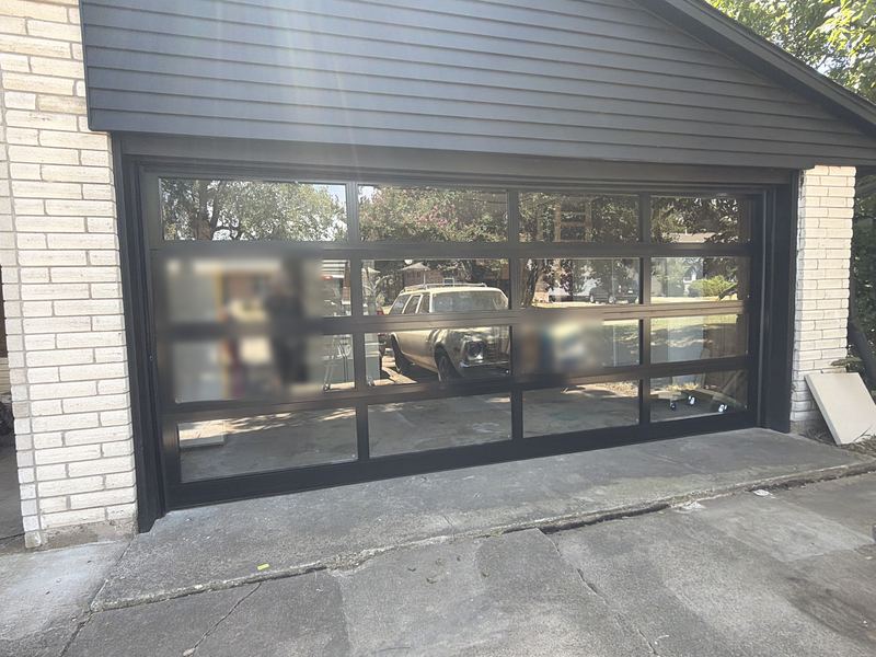 Modern black full-view glass garage door installed in Allen, TX