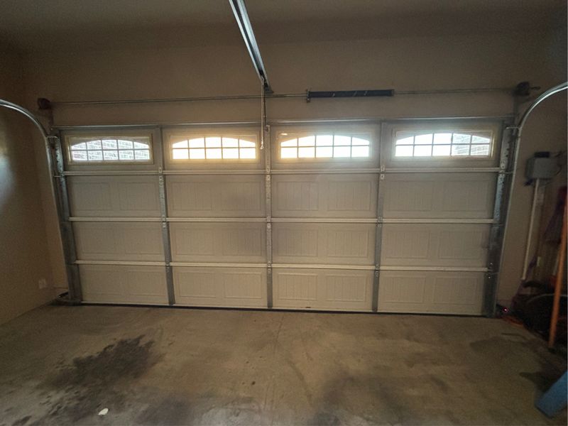 Double garage door with arched windows after new rollers in Glenn Heights, TX