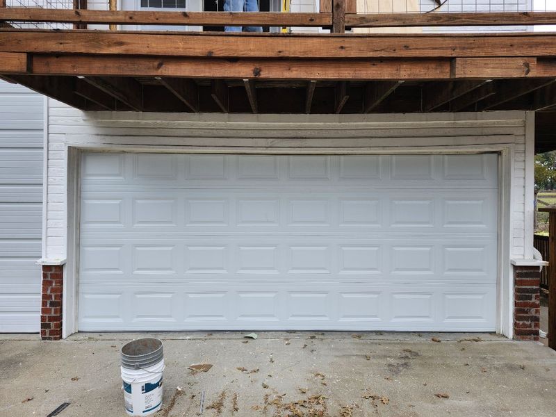 New white raised-panel double garage door installed in Kaufman, TX