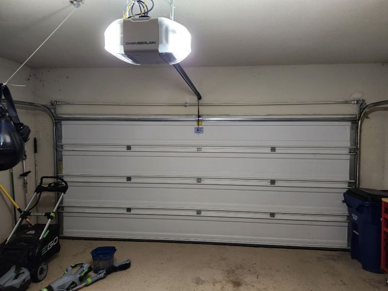 Double garage door with new rollers and opener in Kennedale, TX