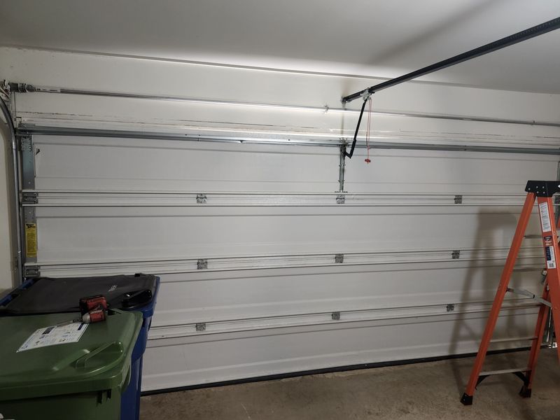 White garage door and track after a repair in Krugerville, TX
