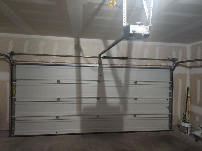 Single-car garage door after spring replacement in Krugerville, TX