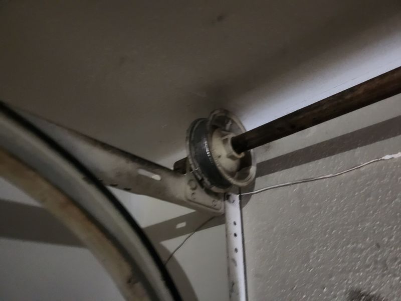 Cable drum and spring checked during a safety tune-up in Lake Highlands, Dallas