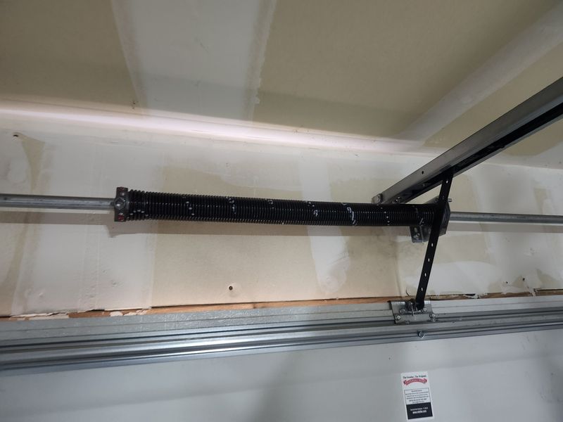 Torsion spring and opener rail above a garage door in Lavon, TX
