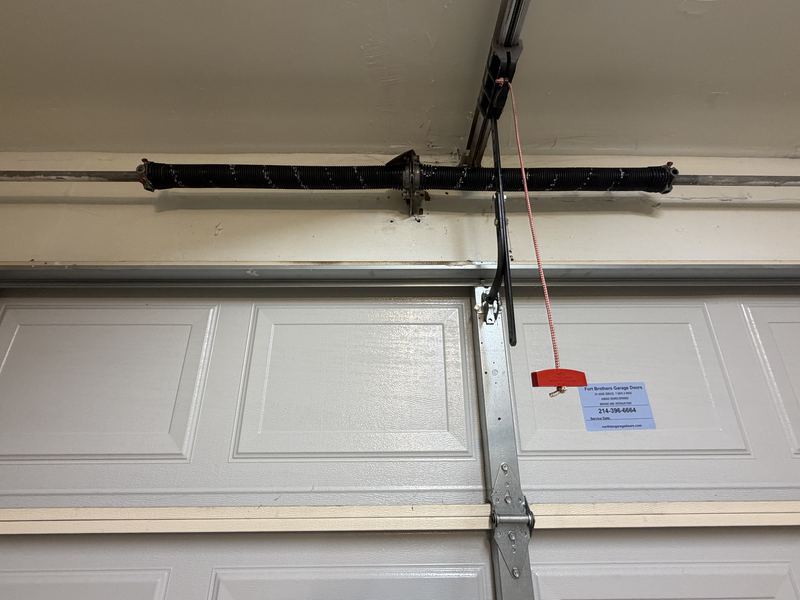 New torsion spring installed on a garage door in Dallas, TX