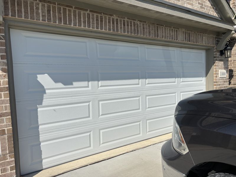 Raised-panel double garage door after service in Oak Point, TX