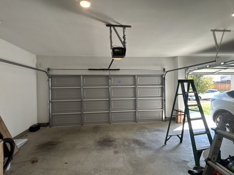 Garage door and opener rail during a spring replacement in Oak Point, TX