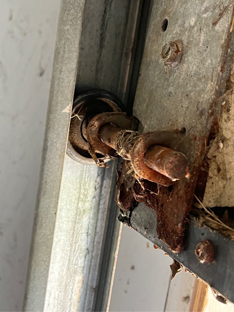 Worn roller and hinge found on a door balance call in Pilot Point, TX