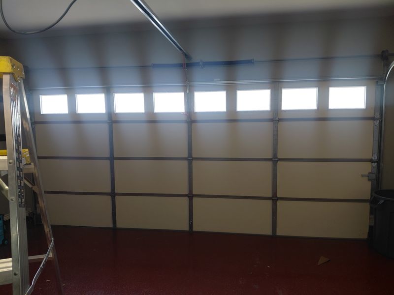 Garage door with window panels after service in River Oaks, TX
