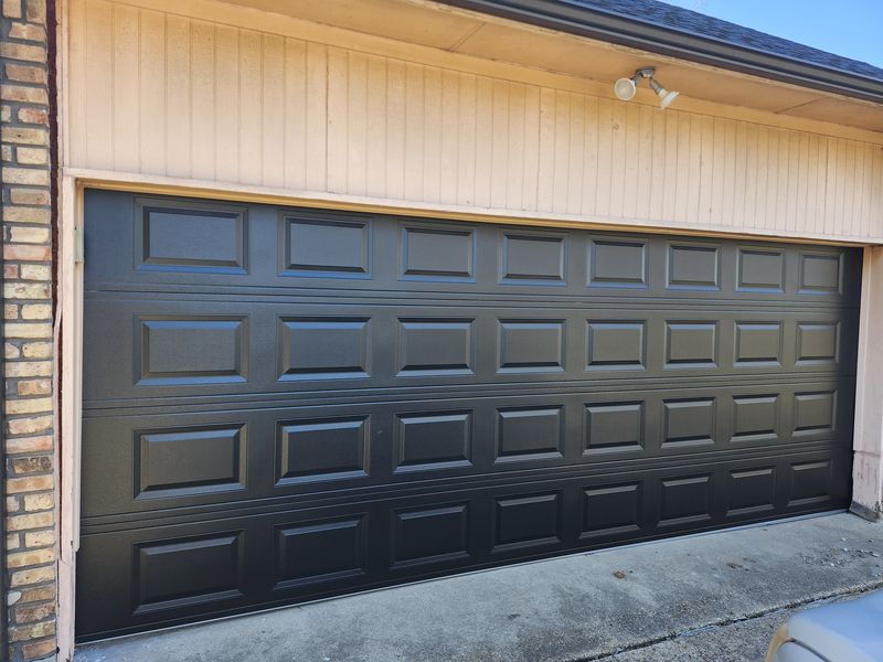 New dark brown raised-panel double garage door installed in Seagoville, TX