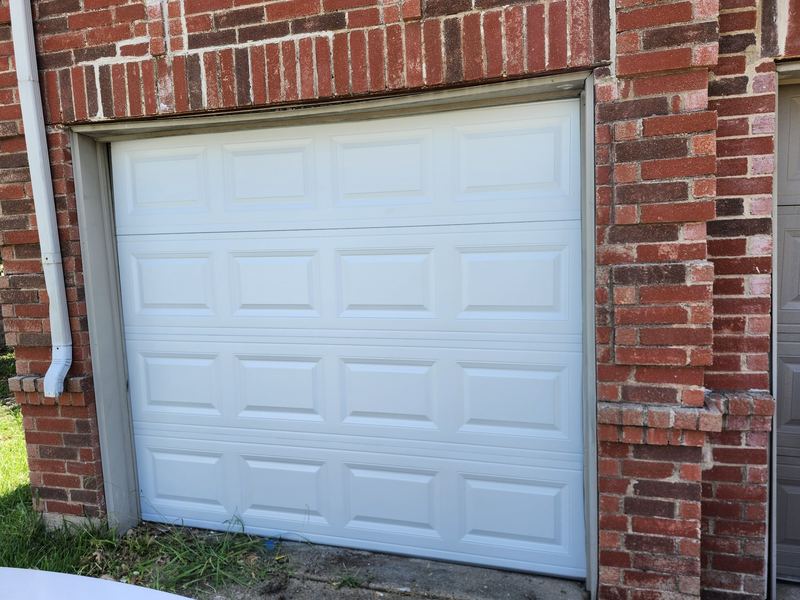 New single-car white garage door installed in Garland, TX
