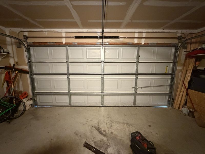 Double garage door with a new strut in Venus, TX