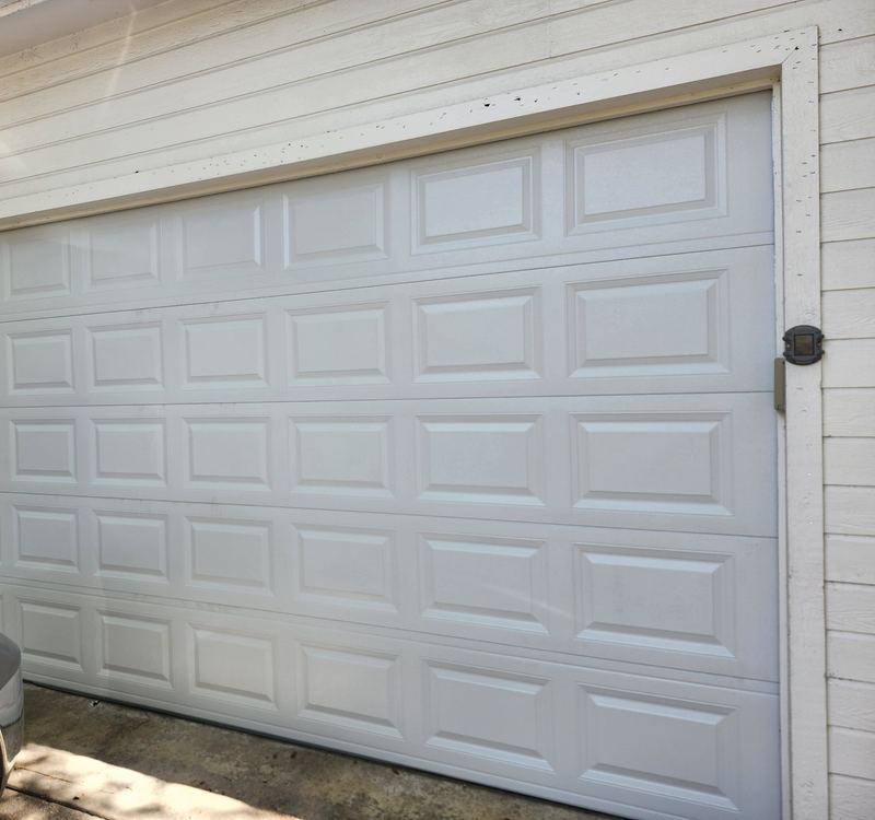New white long-panel steel garage door installed in Coppell, TX