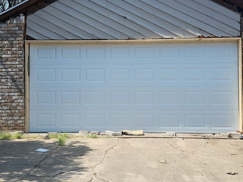 New white raised-panel garage door installed in Plano, TX